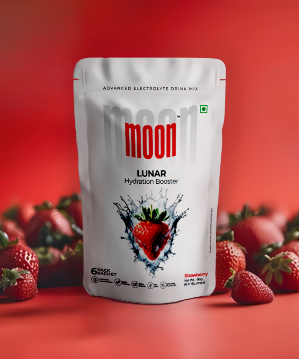 A package of "Moon Strawberry Lunar Hydration Booster Pack of 2" electrolyte drink mix for post-workout recovery, paired with fresh strawberries against a red background by MOONFREEZE FOODS PRIVATE LIMITED.