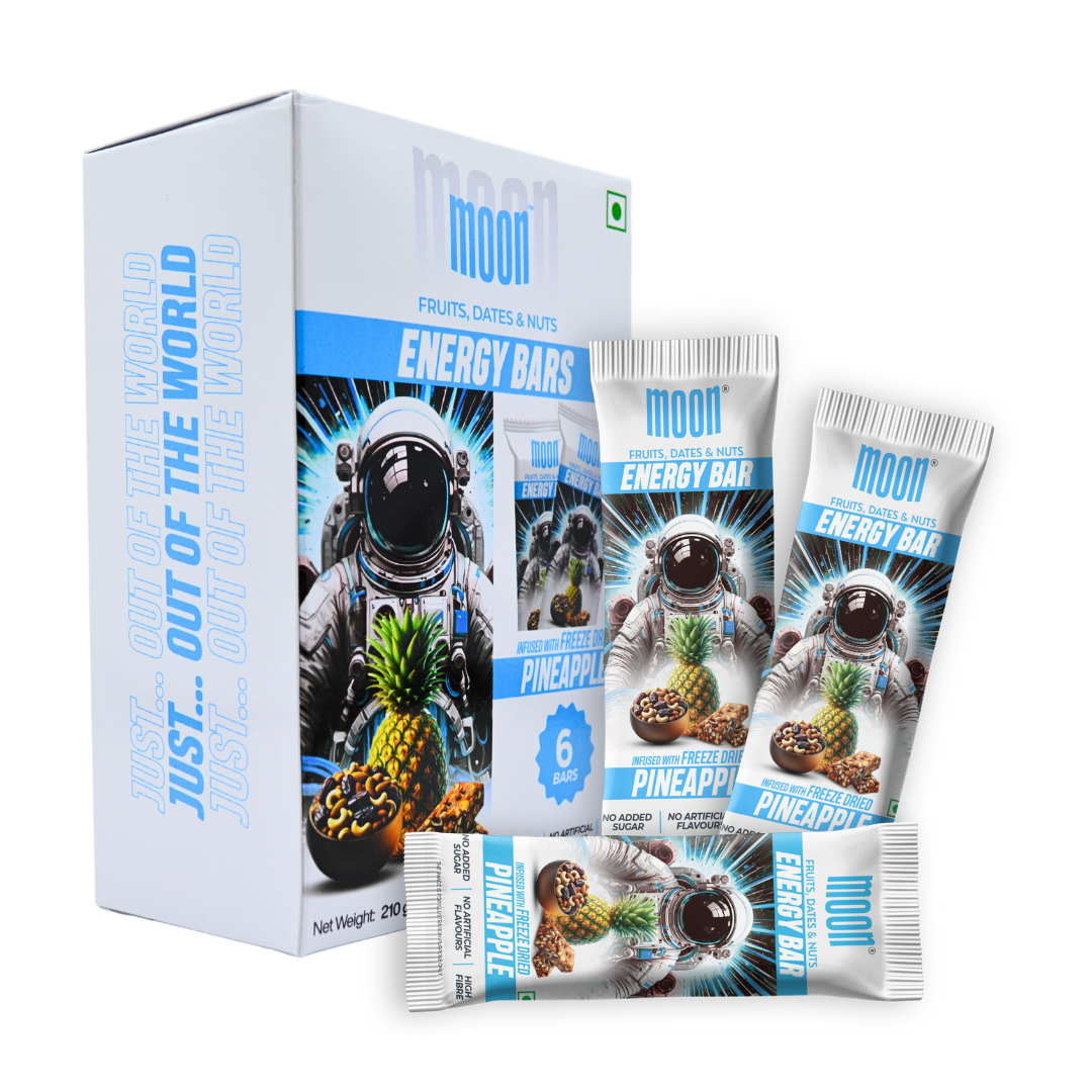 A box of MOON Energy Bars - Pineapple (6 Pack) by MOONFREEZE FOODS PRIVATE LIMITED, featuring flavorful freeze-dried pineapples. Each package contains six meal replacement bars and is adorned with a space-themed design showcasing an astronaut.