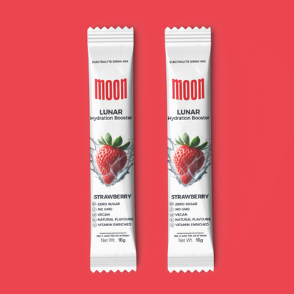 Two packets of Moon Lunar Strawberry Hydration Stick Pack of 2 by MOONFREEZE FOODS PRIVATE LIMITED against a red background. The text indicates they are electrolyte drink mixes, zero sugar, non-GMO, vegan, and vitamin-enriched.