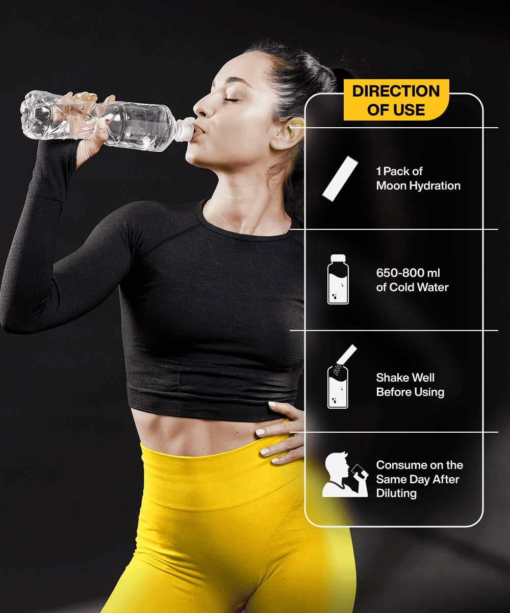 A woman in a black top and yellow pants drinks water from a bottle. The instructions say to mix MOONFREEZE FOODS' Lemon Flavour Lunar Hydration Booster with 650-800 ml of water, shake well, and drink the same day for essential electrolytes and a B-vitamin complex boost.