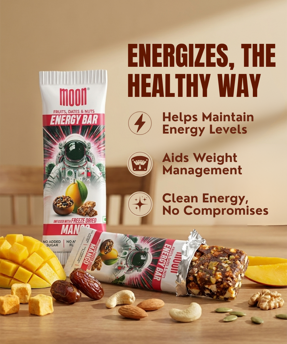 The MOON Energy Bar - Mango from MOONFREEZE FOODS PRIVATE LIMITED is made with fruit and nuts, shown next to freeze-dried mango and dates, for clean energy, weight management, and meal replacement benefits.