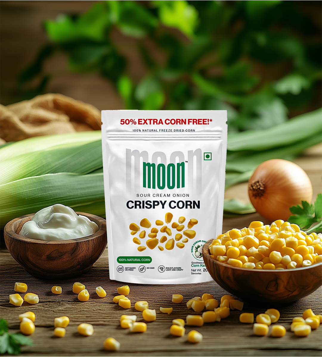 Experience a delightful crunch with every bite of MOONFREEZE FOODS' Freeze Dried Crispy Corn Sour Cream & Onion, surrounded by bowls of corn and fresh green leaves, paired with an inviting array of spices.