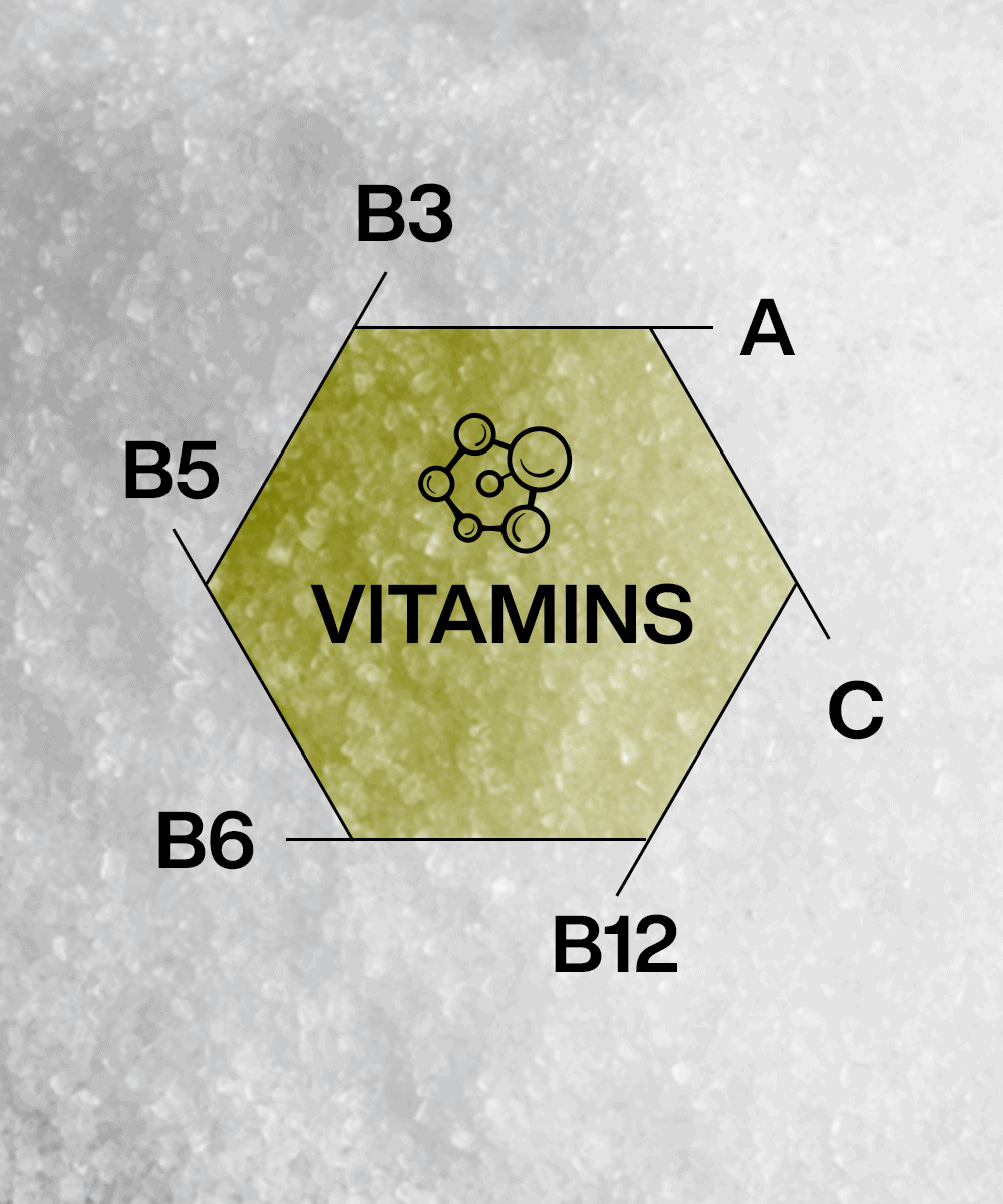 The hexagonal "VITAMINS" diagram displays a B-vitamin complex with A, B3, B5, B6, B12, and C on its edges against a gray textured backdrop echoing the Lunar Hydration Booster - Watermelon's design by MOONFREEZE FOODS PRIVATE LIMITED.