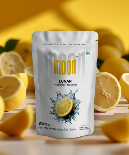 Product packaging for a lemon-flavored "Moon Freeze Orbit Mix Packs - Hydrate & Snack" electrolyte drink mix with freeze-dried fruits, presented against a background with sliced lemons by MOONFREEZE FOODS PRIVATE LIMITED.