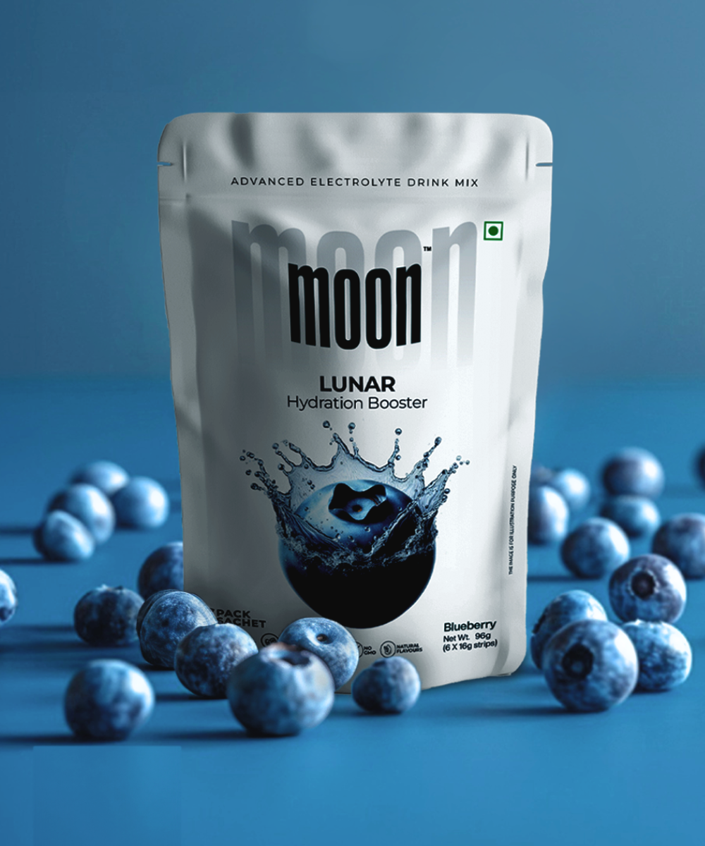 A package of Moon Freeze Astronaut's Diet Pack - Refresh Edition electrolyte mix with a blueberry flavor, surrounded by fresh blueberries on a blue background.