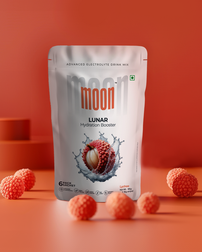 A pack of Moon Lychee Lunar Hydration Booster drink mix with lychee flavor, presented against a matching orange backdrop, surrounded by lychee fruits.
