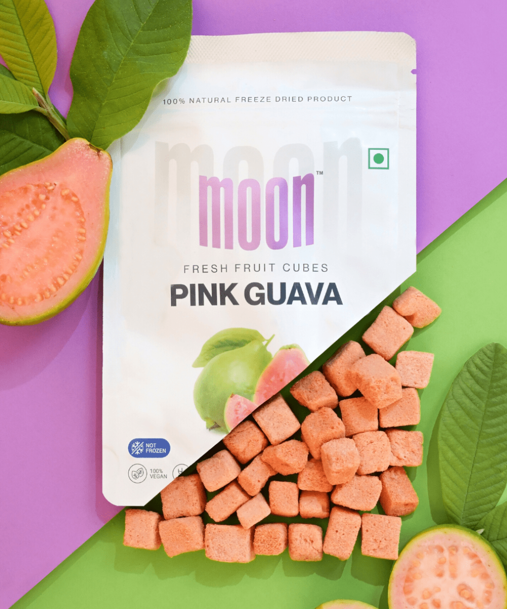 Moon Freeze Celestial Signature Series pink guava cubes next to their packaging on a colorful background, offering a burst of tropical flavors from MOONFREEZE FOODS PRIVATE LIMITED.