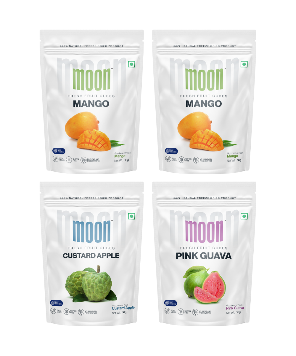 Four packages of Moon Freeze Celestial Signature Series freeze-dried fruit snacks, featuring mango, custard apple, and pink guava tropical flavors by MOONFREEZE FOODS PRIVATE LIMITED.