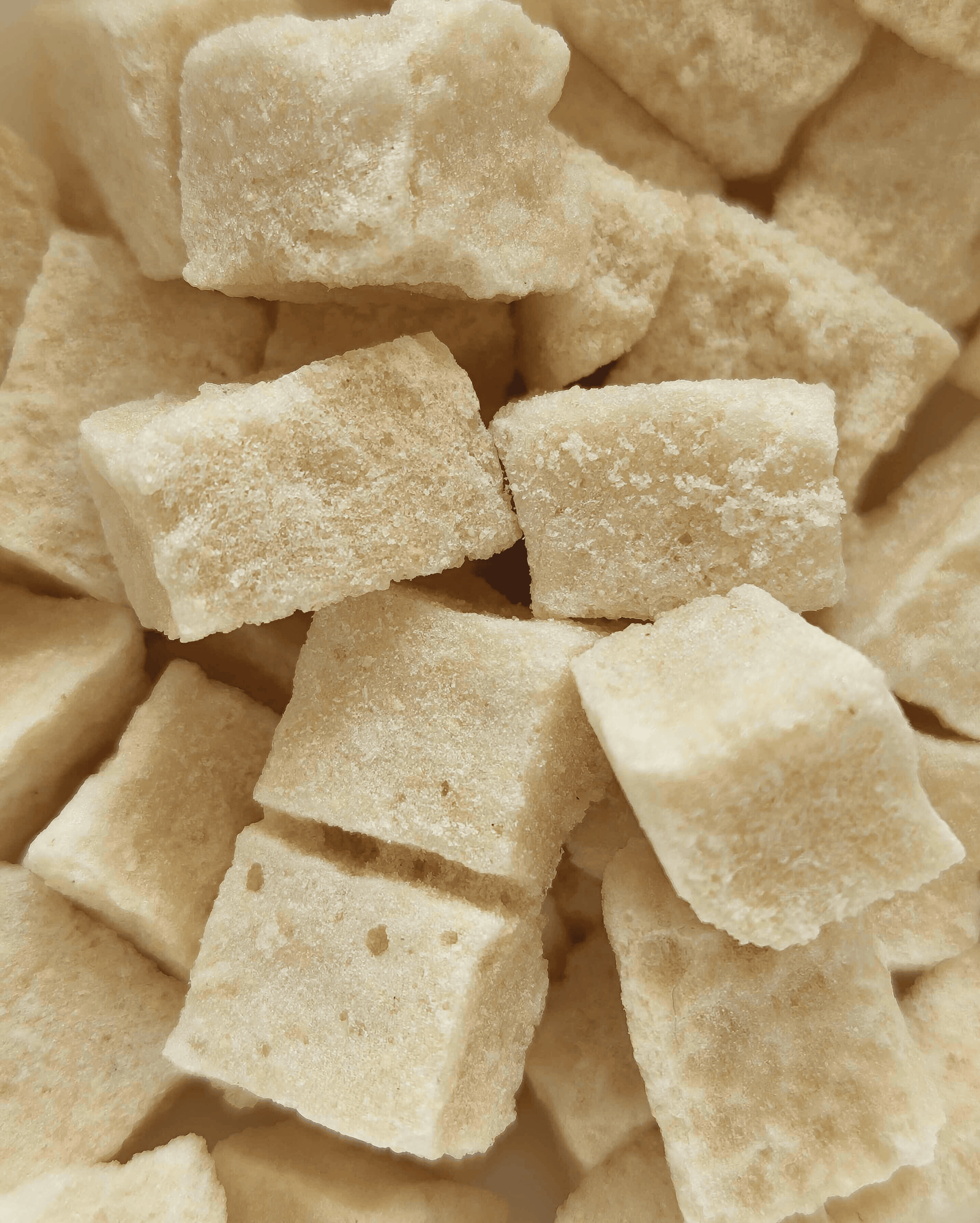 Close-up details of freeze-dried fruit cubes, showcasing their texture and natural color, perfect for the quality and purity of the product.