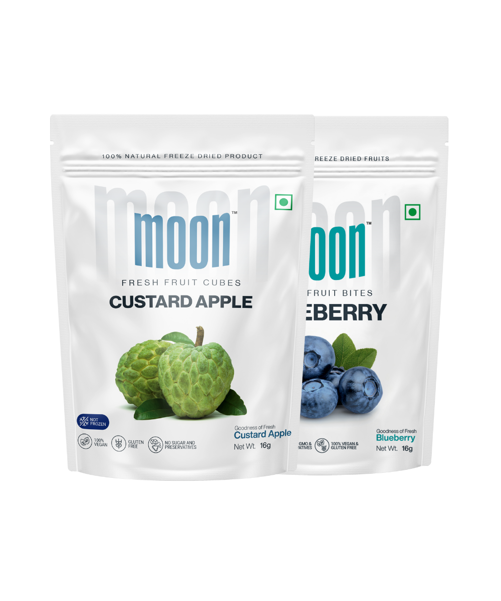 Two packets of MOONFREEZE FOODS PRIVATE LIMITED freeze-dried fruit snack, one with custard apple and the other with blueberry.