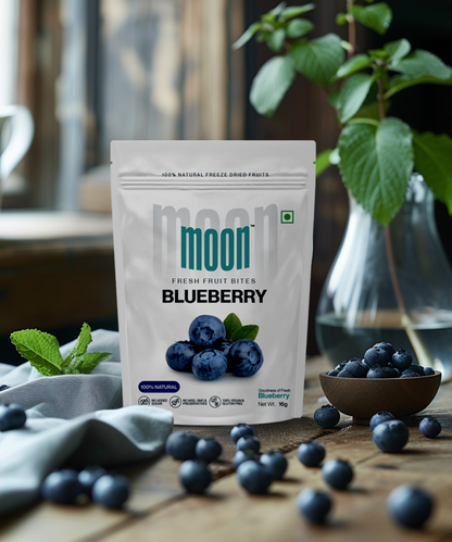  Fresh Fruit Bites in Blueberry flavor, elegantly displayed on a wooden table with fresh blueberries and a vase of green leaves, emphasizing the natural and wholesome qualities of the product.