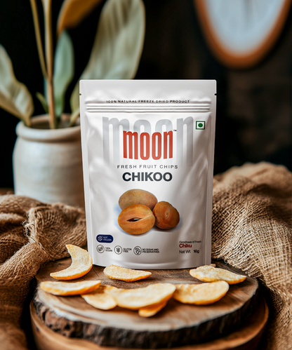 Fruit Chips in Chikoo flavor, displayed on a rustic wooden surface with sliced Chikoo chips, emphasizing the natural and wholesome qualities of the product.