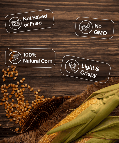 This image shows corn cob, corn kernels, and a brown husk on a wooden surface. Labels highlight features: "Not Baked or Fried," "No GMO," "100% Natural Corn," and "Light & Crispy." Experience the Freeze Dried Crispy Corn Gourmet Cheese by MOONFREEZE FOODS PRIVATE LIMITED with every bite!