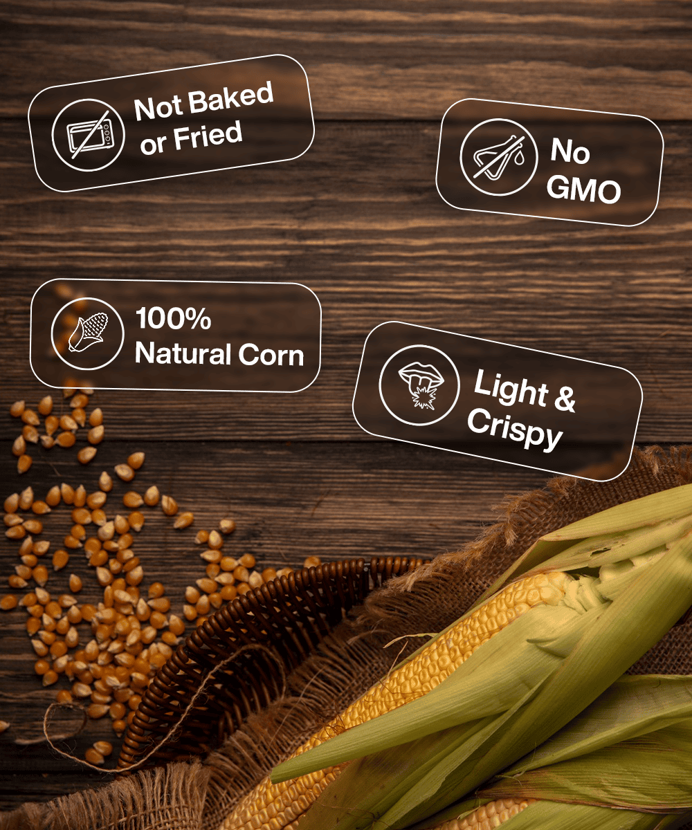 A wooden surface with corn kernels and husked corn. Text labels: "Not Baked or Fried," "No GMO," "100% Natural Corn," and "Light & Crispy." Enjoy this guilt-free treat with every bite of our MOONFREEZE FOODS PRIVATE LIMITED Freeze Dried Crispy Corn Peri Peri, seasoned to perfection!