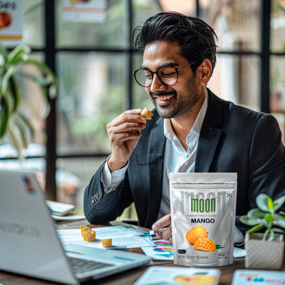 Professional enjoying Mango Cubes at the office, combining work with healthy snacking.