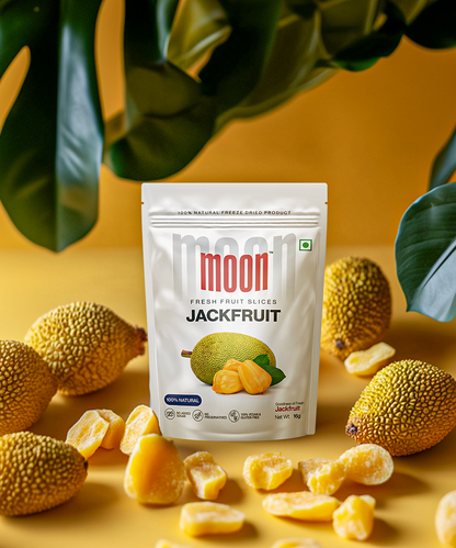 A bag of Moon Freeze Dried Jackfruit from Themoonstoreindia stands upright on a yellow surface, surrounded by fresh whole jackfruits and jackfruit pieces, showcasing the 100% natural, freeze-dried jackfruit chips with numerous health benefits.