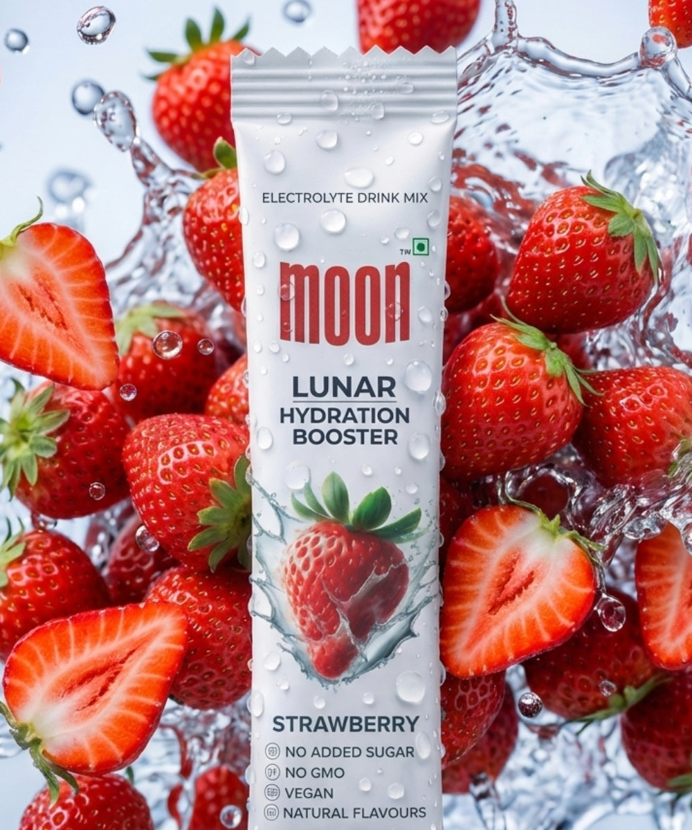 A packet of MOONFREEZE FOODS PRIVATE LIMITED Lunar Hydration Booster - Strawberry Flavour is displayed among fresh strawberries with water droplets.