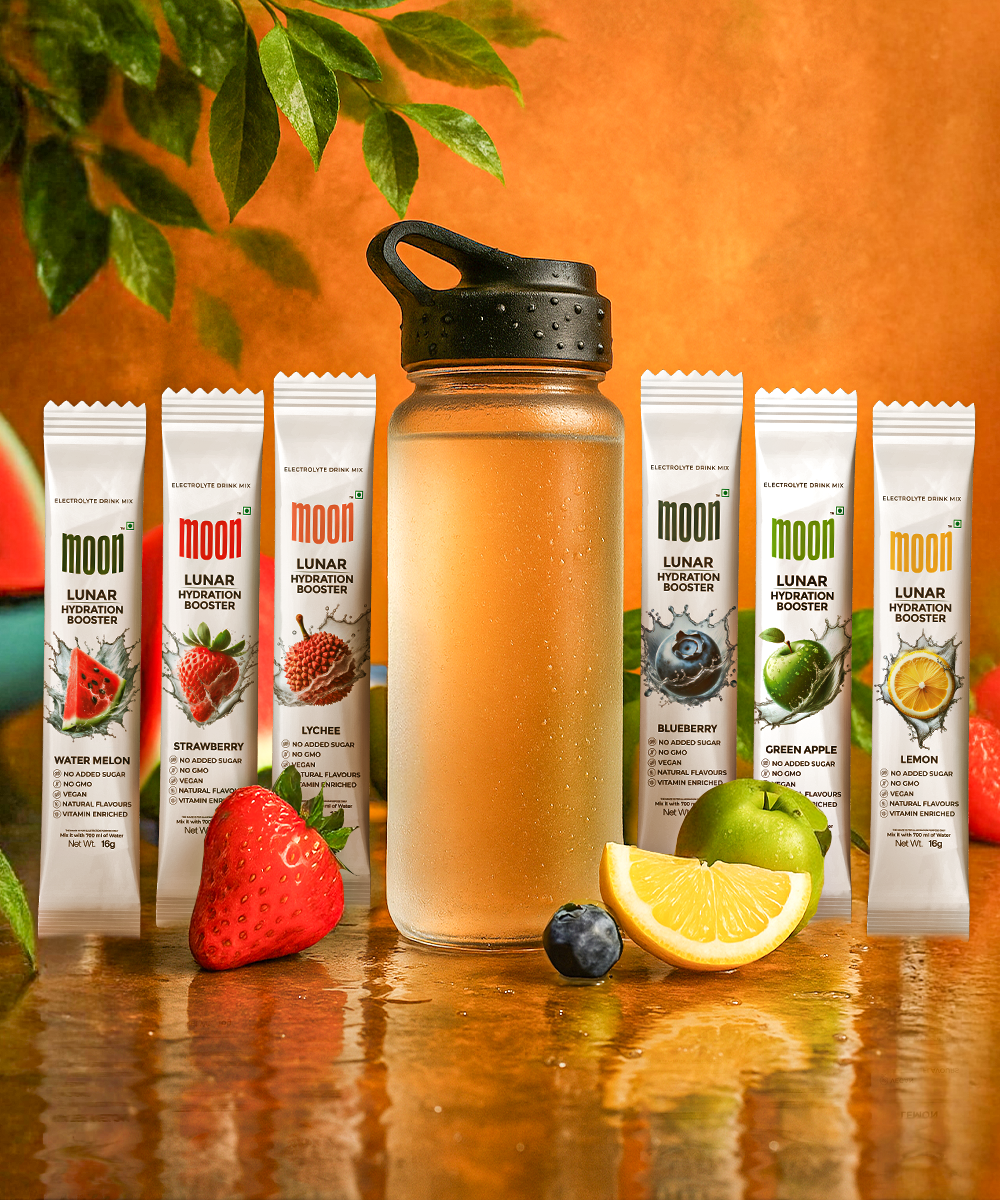 A water bottle is surrounded by seven MOONFREEZE FOODS PRIVATE LIMITED Lunar Hydration Booster - Variety Pack packets in assorted flavors, plus strawberries, a blueberry, lemon and lime slices. Each packet delivers essential electrolytes for peak hydration.