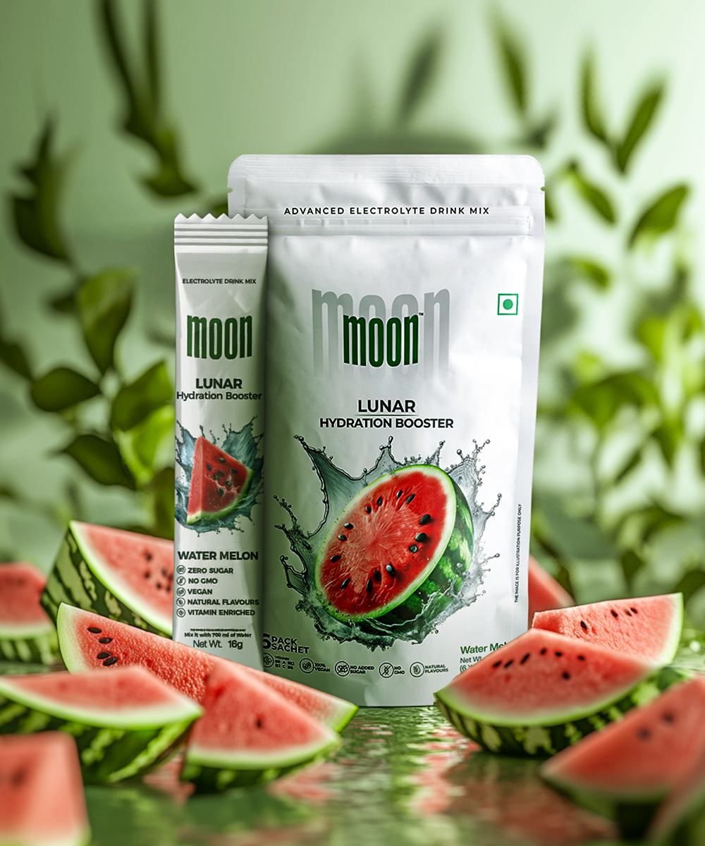 Introducing the Lunar Hydration Booster - Watermelon by MOONFREEZE FOODS PRIVATE LIMITED: a watermelon-flavored electrolyte and B-vitamin drink. Each sachet is in a packet labeled "Moon," featuring juicy watermelon slices on a fresh green background.