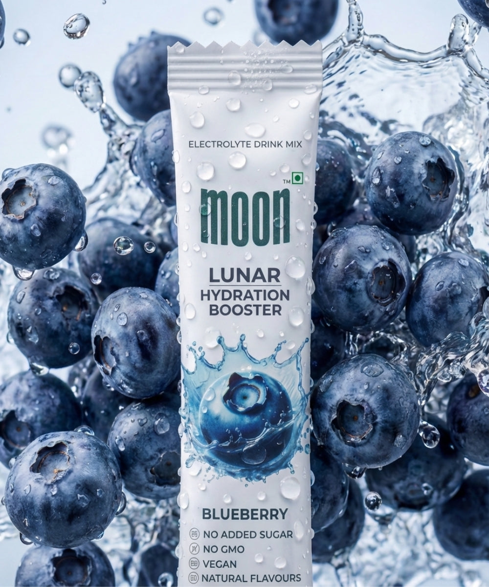 A packet of MOONFREEZE FOODS PRIVATE LIMITED Lunar Hydration Booster - Blueberry Flavour electrolyte drink mix with no added sugar, surrounded by fresh blueberries and water splashes.