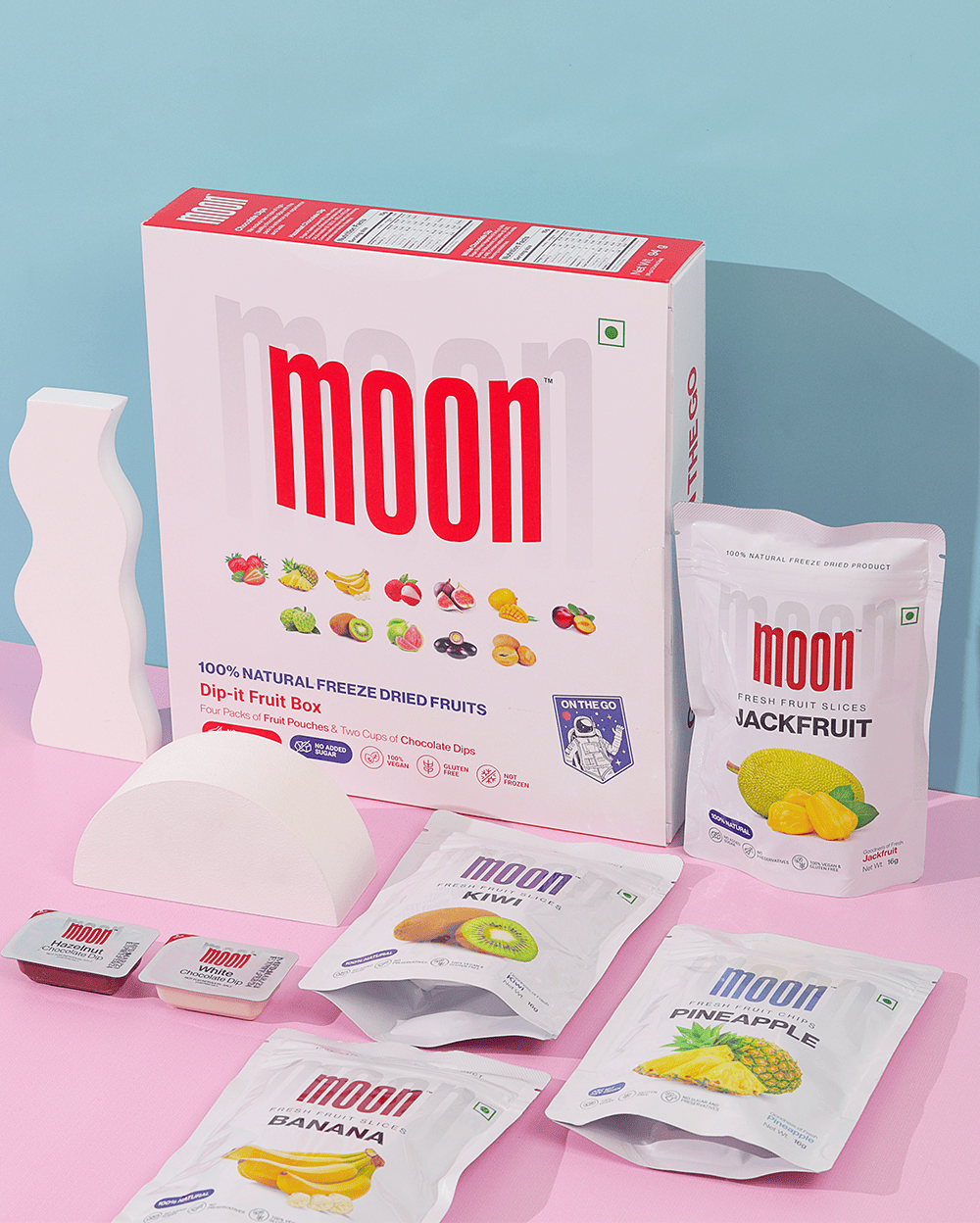 A box of Themoonstoreindia Moon Freeze Dried Exotic Dip it fruit snacks on a pink background.