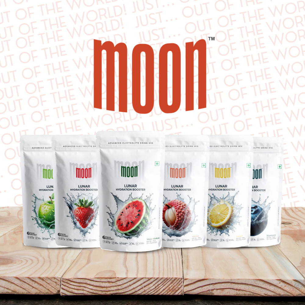 A display of MOONFREEZE FOODS PRIVATE LIMITED Moon Lunar Hydration - Pack of 36 (Monthly Pack) packets in various flavors on a wooden surface, with the Moon logo and "Out of This World!" slogan in the background. The perfect hydration booster loaded with essential electrolytes and vitamins.